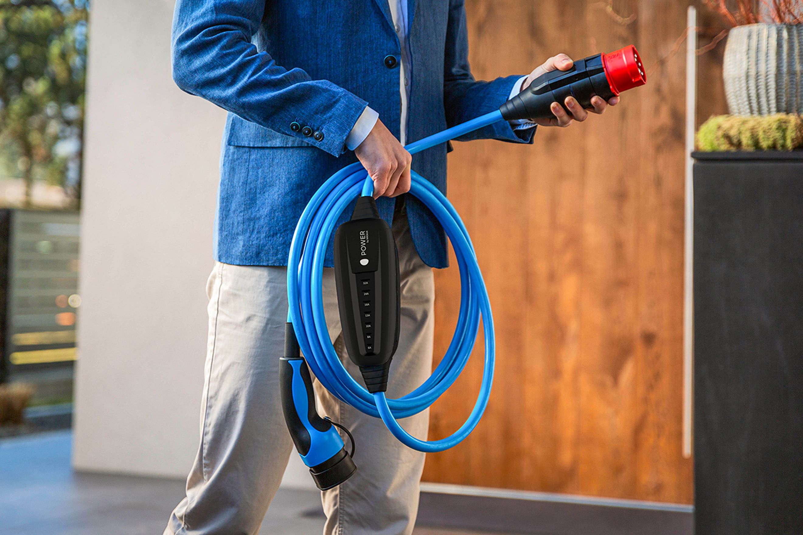 A man holds the plug of a cable in his hand